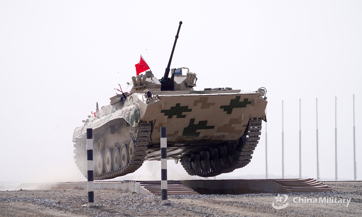 An infantry fighting vehicle of the Iranian team crosses the treadway bridge setup in the first round of individual race of the Suvorov Onslaught contest in Korla, China's Xinjiang Uygur Autonomous Region, on August 14, 2022. The Suvorov Onslaught of the International Army Games 2022 (IAG 2022) kicked off on August 14 with participation of six teams from five countries, namely China, Russia, Belarus, Iran and Venezuela. (Photo by Luan Cheng)