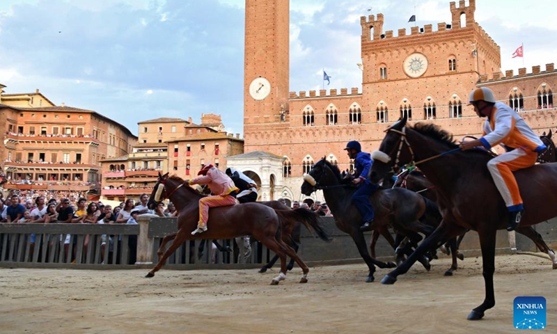 Jockeys ride horses during the trial of the horse race Palio in Siena, Italy, Aug. 15, 2022. Siena is famous for its medieval cityscape and the horse race Palio. The historic center of Siena was inscribed on the UNESCO World Heritage List in 1995.(Photo: Xinhua)