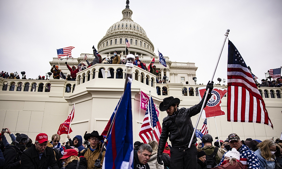 Pro-Trump supporters storm the US Capitol following a rally with President Donald Trump on January 6, 2021 in Washington, DC. Trump supporters gathered in the nation's capital to protest the ratification of President-elect Joe Biden's Electoral College victory over President Trump in the 2020 election. Photo: Samuel Corum/Getty Images/VCG