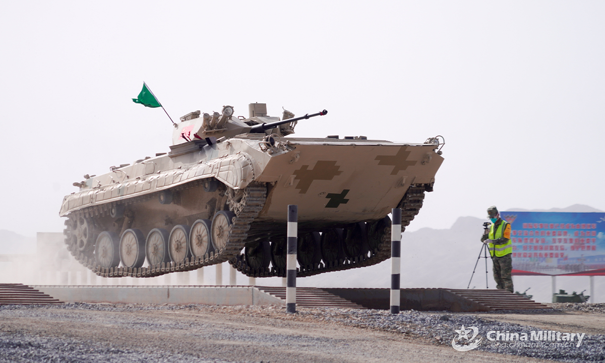 An infantry fighting vehicle of the Chinese team leaps forward on the treadway bridge setup in the first round of individual race of the Suvorov Onslaught contest in Korla, China's Xinjiang Uygur Autonomous Region, on August 14, 2022. The Suvorov Onslaught of the International Army Games 2022 (IAG 2022) kicked off on August 14 with participation of six teams from five countries, namely China, Russia, Belarus, Iran and Venezuela. (Photo by Luan Cheng)