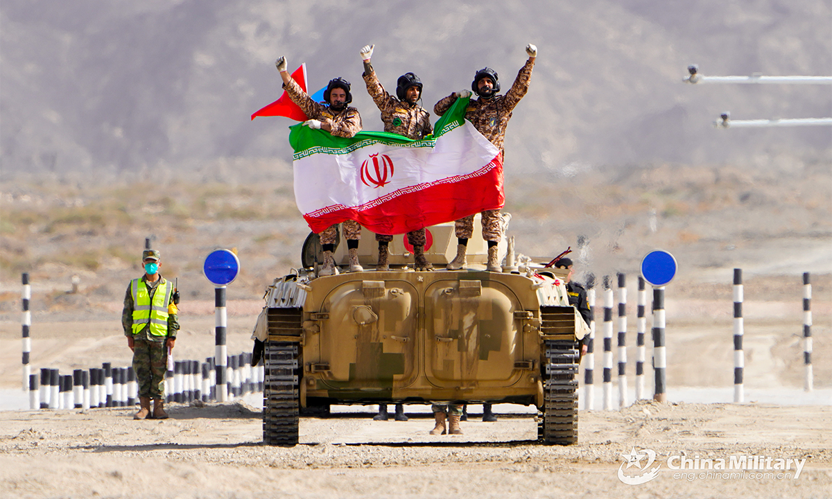 The infantry fighting vehicle crew of the Iranian team displays the national flag of Iran after the first round of individual race of the Suvorov Onslaught contest in Korla, China's Xinjiang Uygur Autonomous Region, on August 14, 2022. The Suvorov Onslaught of the International Army Games 2022 (IAG 2022) kicked off on August 14 with participation of six teams from five countries, namely China, Russia, Belarus, Iran and Venezuela. (Photo by Lin Yong)