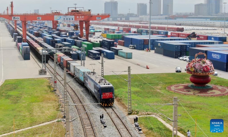 Aerial photo taken on Aug. 23, 2022 shows a China-Vietnam freight train pulling out of Xi'an international port in Xi'an, northwest China's Shaanxi Province. The freight train left the Xi'an international port in Shaanxi Province on Tuesday for Vietnam's Hanoi, marking the first China-Vietnam freight train route connecting Shaanxi and Vietnam.

The train was loaded with 41 carriages of asbestos which were transported from Kazakhstan to Xi'an via the China-Europe freight train service. (Xinhua/Li Yibo)
