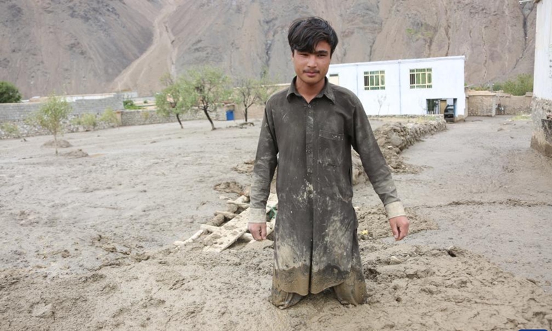 A man stands in the mud in Parwan province, Afghanistan, Aug. 15, 2022. At least 17 people have been confirmed dead and scores of houses washed away as flash floods swept through several villages in Shinwari district and adjoining areas in eastern Afghanistan's Parwan province on Sunday, district chief Mullah Khan Mohammad said Monday.(Photo: Xinhua)