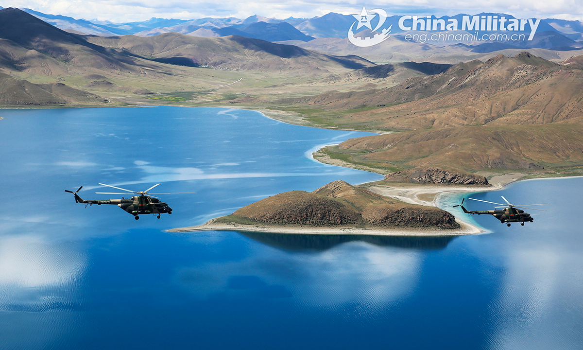 Transport helicopters attached to an army aviation brigade under the PLA Xizang Military Command fly over the alpine lakes during flight training in an unfamiliar plateau area in mid August, 2022. (eng.chinamil.com.cn/Photo by Hu Qiwu)