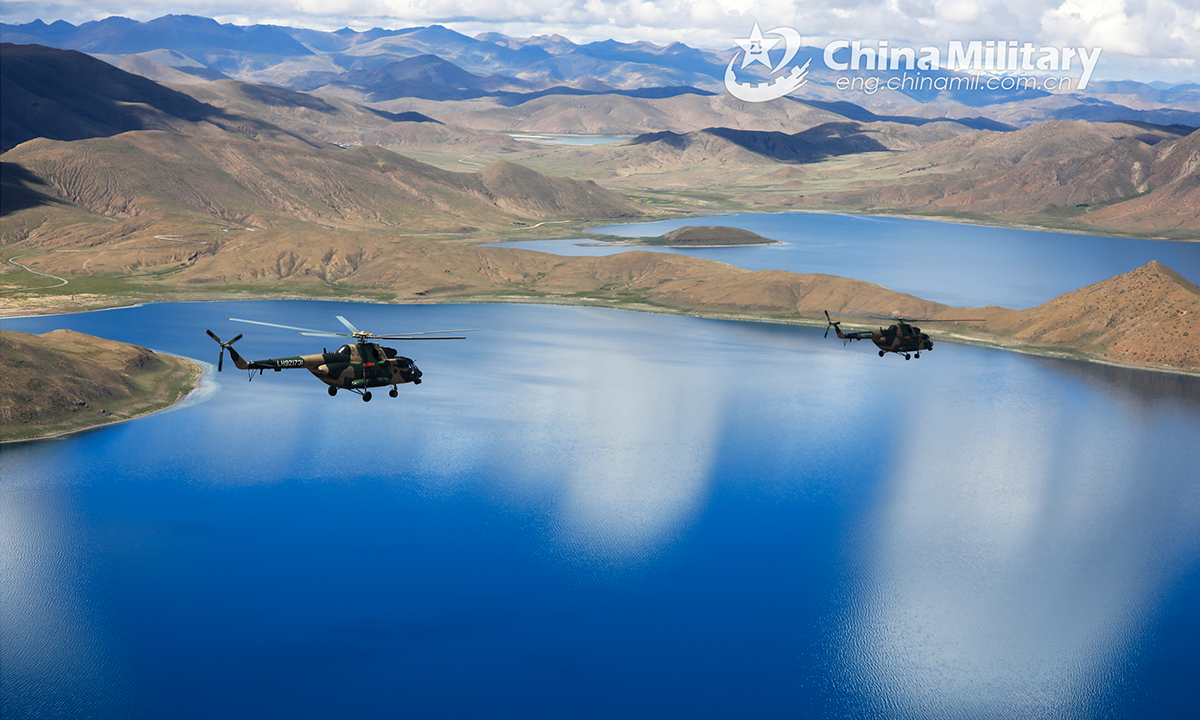 Transport helicopters attached to an army aviation brigade under the PLA Xizang Military Command fly over the alpine lakes during flight training in an unfamiliar plateau area in mid August, 2022. (eng.chinamil.com.cn/Photo by Hu Qiwu)