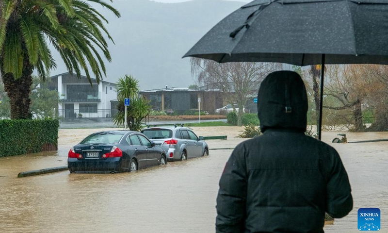 A pedestrian stands at a flooded area in Nelson of South Island, New Zealand, Aug. 18, 2022. The West Coast and Nelson-Tasman regions of New Zealand's South Island have been hit hard by heavy rain and flooding.(Photo: Xinhua)