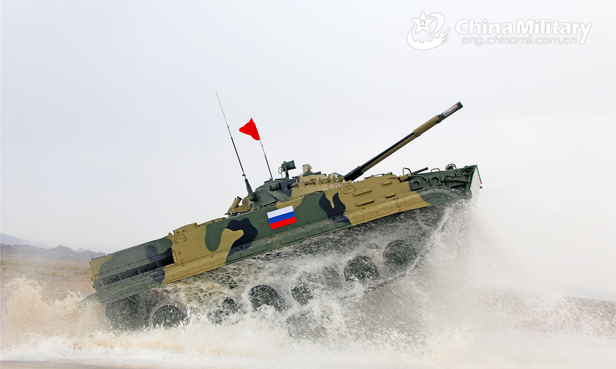 An infantry fighting vehicle of the Russian participating team passes through the water barrier during the second round of individual race of the Suvorov Onslaught contest in Korla, China's Xinjiang Uygur Autonomous Region, on August 16, 2022. The Suvorov Onslaught contest of the International Army Games 2022 (IAG 2022) kicked off on August 14 with participation of six teams from five countries, namely China, Russia, Belarus, Iran and Venezuela. (Photo by Liu Xun and Luo Xingcang)