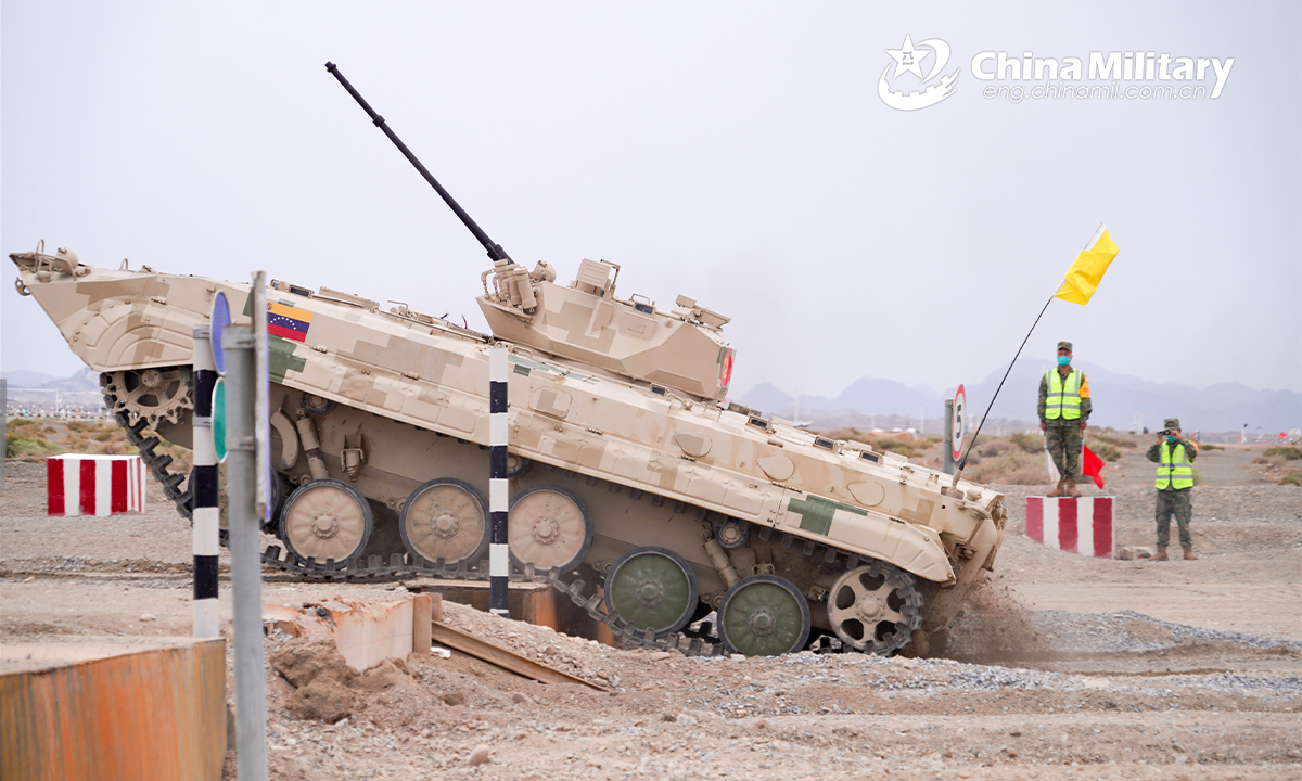An infantry fighting vehicle of the Venezuelan participating team passes through an anti-tank scarp obstacle during the second round of individual race of the Suvorov Onslaught contest in Korla, China's Xinjiang Uygur Autonomous Region, on August 16, 2022. The Suvorov Onslaught contest of the International Army Games 2022 (IAG 2022) kicked off on August 14 with participation of six teams from five countries, namely China, Russia, Belarus, Iran and Venezuela. (Photo by Luan Cheng)