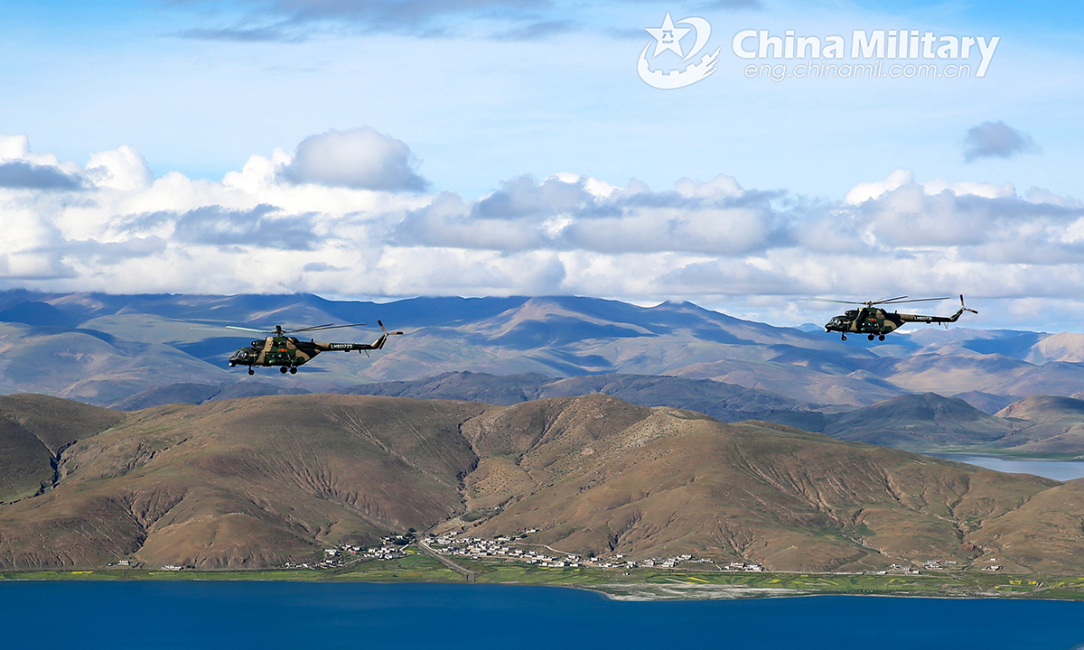 Transport helicopters attached to an army aviation brigade under the PLA Xizang Military Command fly over the alpine lakes during flight training in an unfamiliar plateau area in mid August, 2022. (eng.chinamil.com.cn/Photo by Hu Qiwu)
