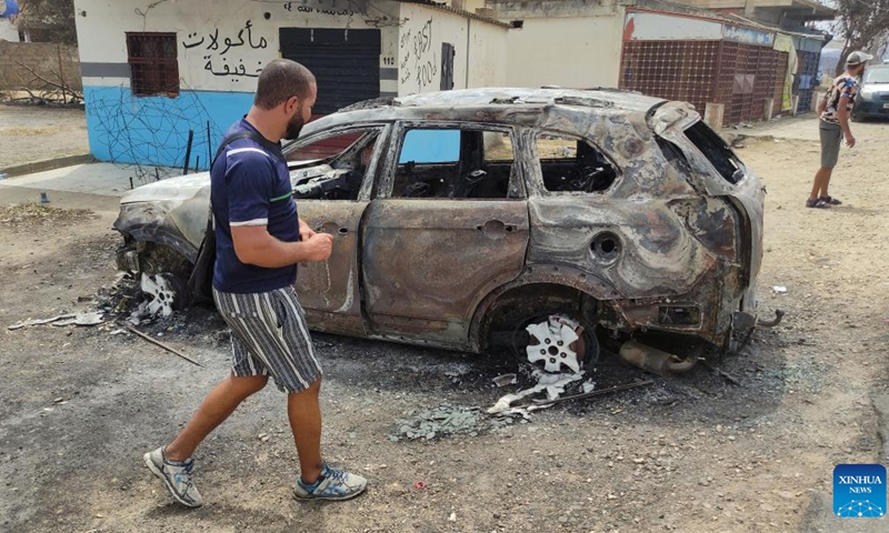 People gather near a site where a forest fire occurred in El Tarf province, Algeria, on Aug. 18, 2022. At least 37 people were killed and 235 others injured in forest fires that have ravaged large parts of the country, said a statement of the Algerian civil protection authority on Thursday.(Photo: Xinhua)