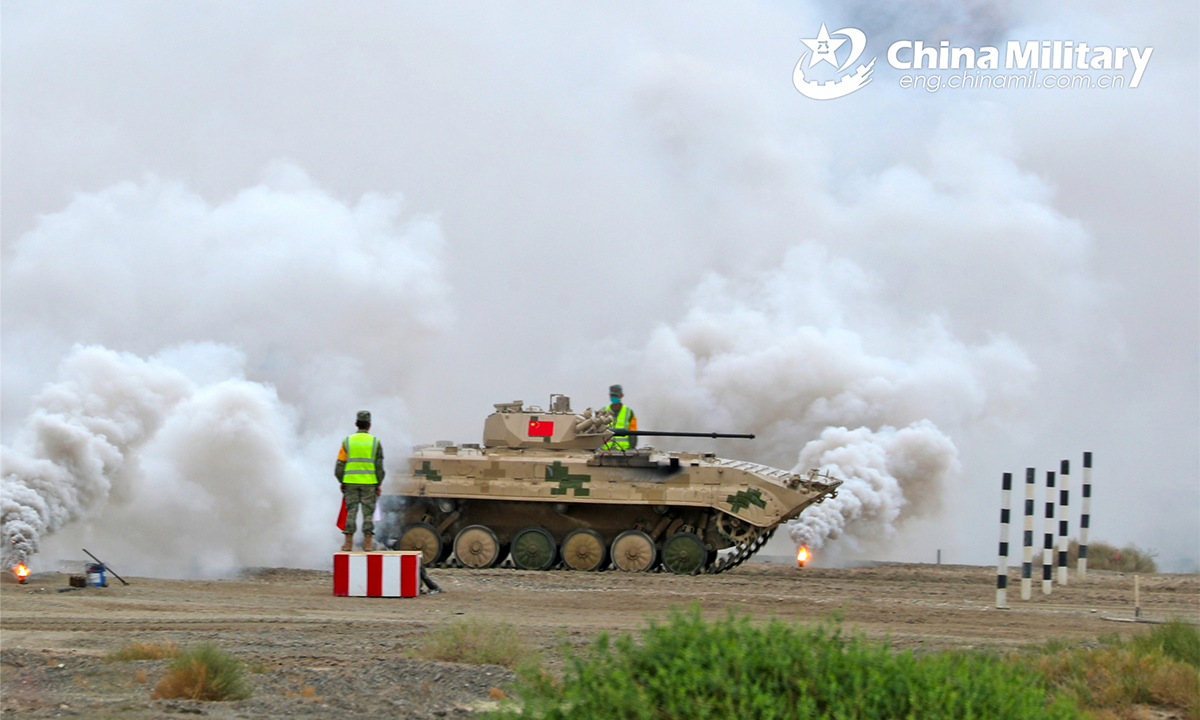 An infantry fighting vehicle of the Chinese participating team passes through smokescreen obstacle during the second round of individual race of the Suvorov Onslaught contest in Korla, China's Xinjiang Uygur Autonomous Region, on August 16, 2022. The Suvorov Onslaught contest of the International Army Games 2022 (IAG 2022) kicked off on August 14 with participation of six teams from five countries, namely China, Russia, Belarus, Iran and Venezuela. (Photo by Luo Xingcang)