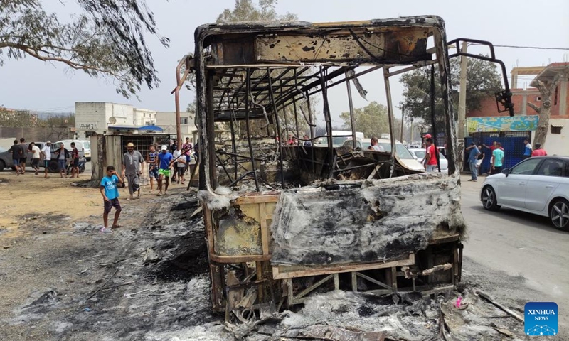 People gather near a site where a forest fire occurred in El Tarf province, Algeria, on Aug. 18, 2022. At least 37 people were killed and 235 others injured in forest fires that have ravaged large parts of the country, said a statement of the Algerian civil protection authority on Thursday.(Photo: Xinhua)