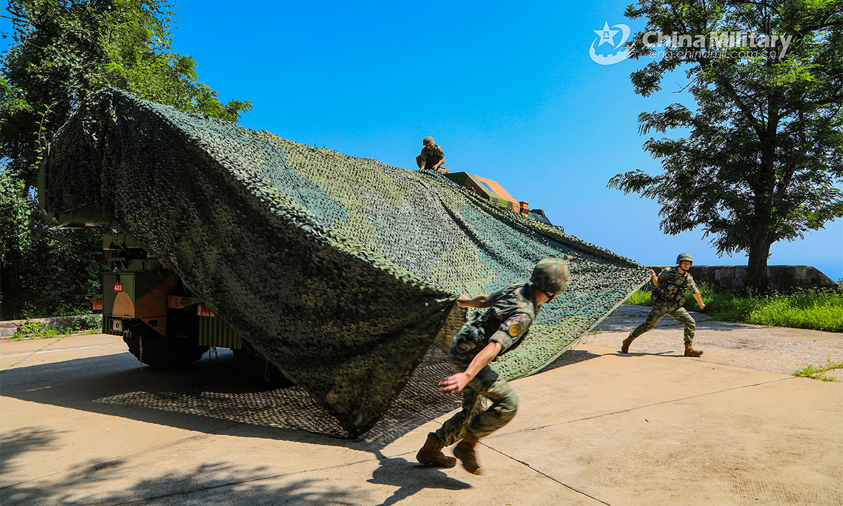 Soldiers assigned to a naval coast-defense missile regiment under the PLA Northern Theater Command dismantle a camouflage net from an anti-ship missile launching vehicle during a recent combat training exercise. The exercise was aimed at testing the troops' capability of winning under real combat conditions. (eng.chinamil.com.cn/Photo by Peng Xi, Liu Zihao, Teng Hao and Han Shuai)
