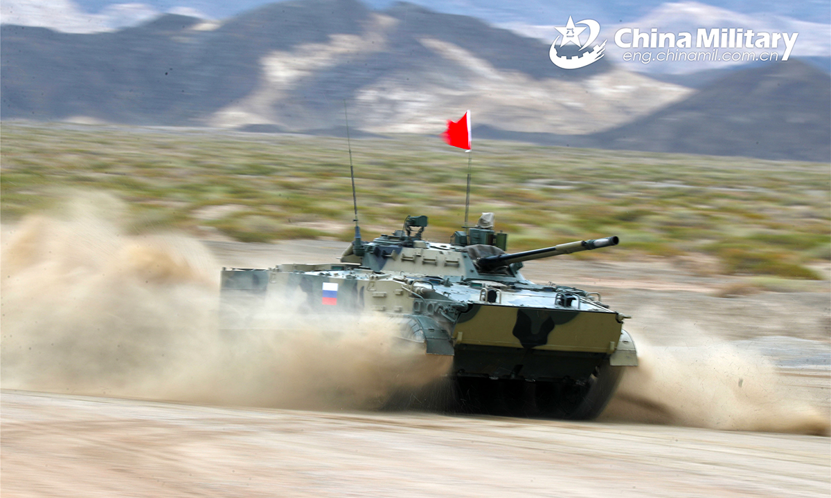 An infantry fighting vehicle of the Russian participating team hurtles down the track during the second round of individual race of the Suvorov Onslaught contest in Korla, China's Xinjiang Uygur Autonomous Region, on August 16, 2022. The Suvorov Onslaught contest of the International Army Games 2022 (IAG 2022) kicked off on August 14 with participation of six teams from five countries, namely China, Russia, Belarus, Iran and Venezuela. (Photo by Luan Cheng)