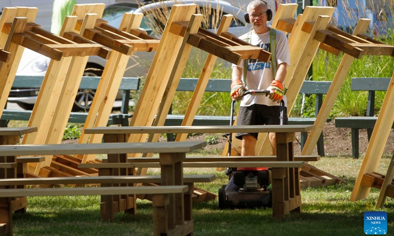 A worker mows the grass for the upcoming the Pacific National Exhibition Fair in Vancouver, British Columbia, Canada, on Aug. 18, 2022. The Pacific National Exhibition (PNE) Fair will be held from Aug. 20 to Sept. 5.(Photo: Xinhua)
