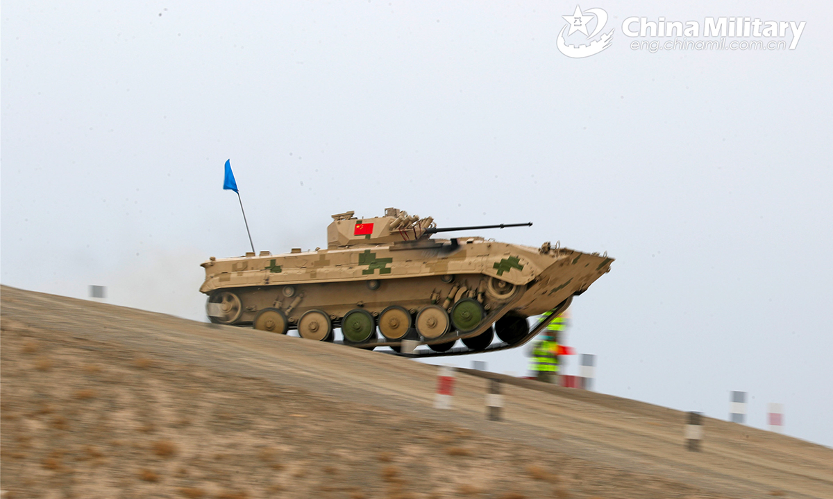 An infantry fighting vehicle of the Chinese participating team drives down the hillside during the second round of individual race of the Suvorov Onslaught contest in Korla, China's Xinjiang Uygur Autonomous Region, on August 16, 2022. The Suvorov Onslaught contest of the International Army Games 2022 (IAG 2022) kicked off on August 14 with participation of six teams from five countries, namely China, Russia, Belarus, Iran and Venezuela. (Photo by Luo Xingcang)
