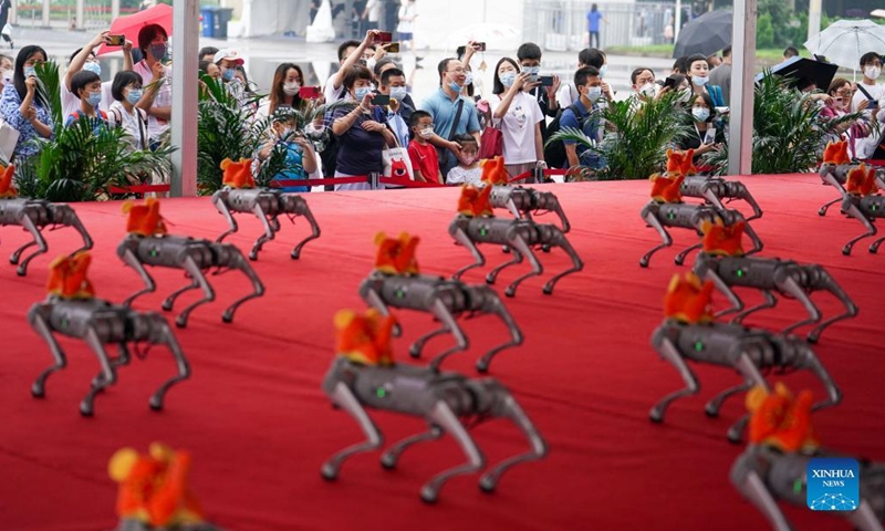 Visitors take pictures of robot dogs during an expo of the World Robot Conference 2022 (WRC 2022) in Beijing, capital of China, Aug. 18, 2022. The WRC 2022 is held from Aug. 18 to 21 in Beijing. More than 500 sets of robots are displayed during the conference and over 30 of them make their world debuts in Beijing. The conference, which is held both online and offline, features three major events including forum, expo and competition.(Photo: Xinhua)