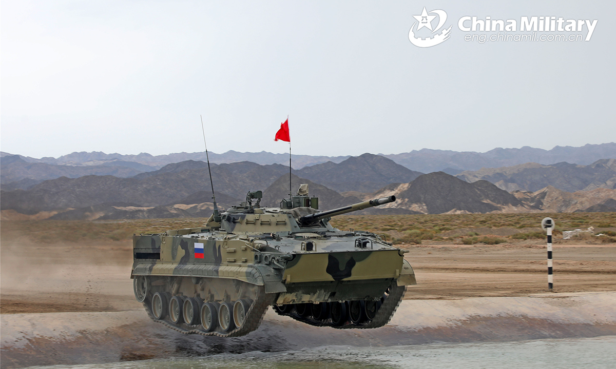 An infantry fighting vehicle of the Russian participating team passes through the water barrier during the second round of individual race of the Suvorov Onslaught contest in Korla, China's Xinjiang Uygur Autonomous Region, on August 16, 2022. The Suvorov Onslaught contest of the International Army Games 2022 (IAG 2022) kicked off on August 14 with participation of six teams from five countries, namely China, Russia, Belarus, Iran and Venezuela. (Photo by Liu Xun and Luo Xingcang)