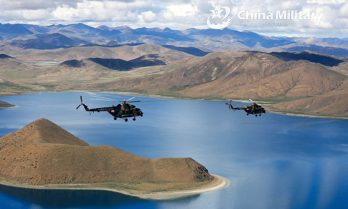 Transport helicopters attached to an army aviation brigade under the PLA Xizang Military Command fly over the alpine lakes during flight training in an unfamiliar plateau area in mid August, 2022. (eng.chinamil.com.cn/Photo by Hu Qiwu)