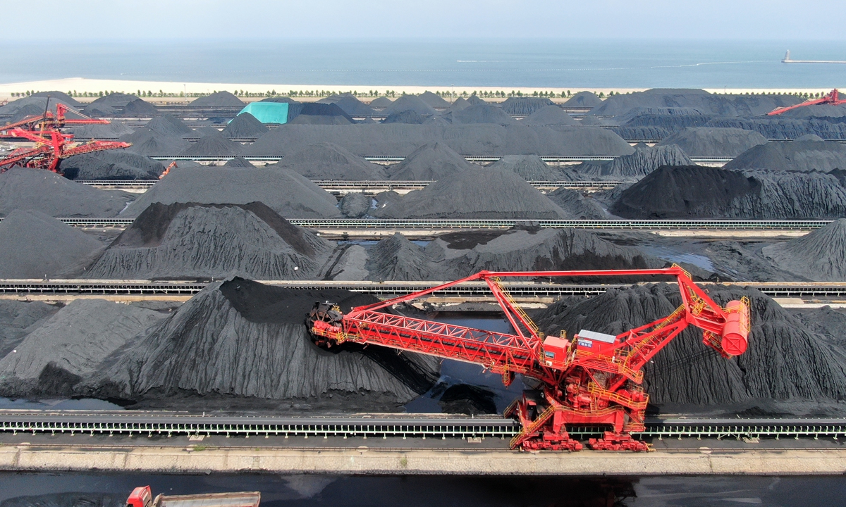 A view of the coal yard at the Rizhao Port, East China's Shandong Province on August 18, 2022. Red reclaimers are rumbling, with trains full of goods ready to be exported. In July, China exported 230,000 tons of coal and lignite, a year-on-year increase of 171.6 percent, customs data showed. Photo: VCG
