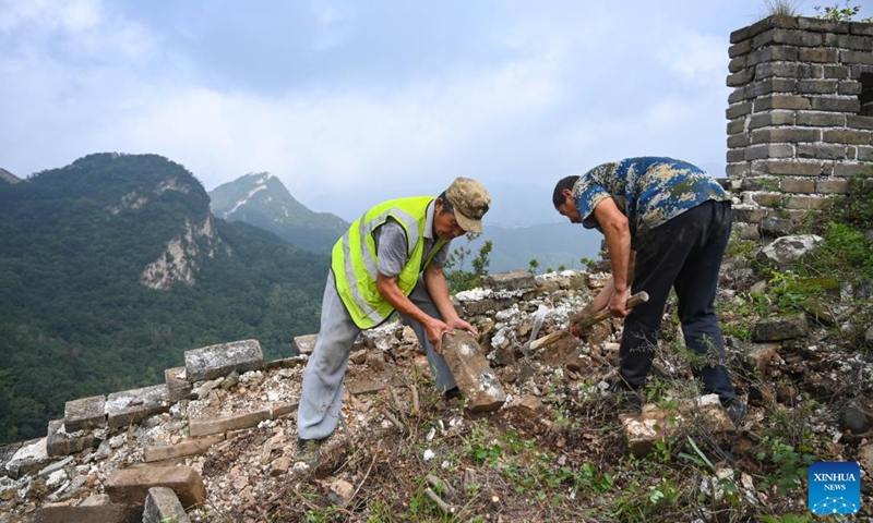 Workers work at an archeological site of the research-based restoration part of the Jiankou section of the Great Wall in Beijing, capital of China, Aug. 17, 2022.Photo:Xinhua