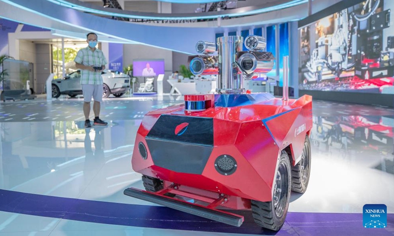 A staff member demonstrates an explosion-proof robot for inspection in chemical facilities at the venue of the 2022 Smart China Expo in southwest China's Chongqing, Aug. 21, 2022.Photo:Xinhua