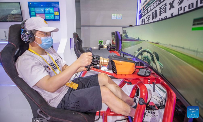 A staff member demonstrates an E-sports simulator at the venue of the 2022 Smart China Expo in southwest China's Chongqing, Aug. 21, 2022.Photo:Xinhua