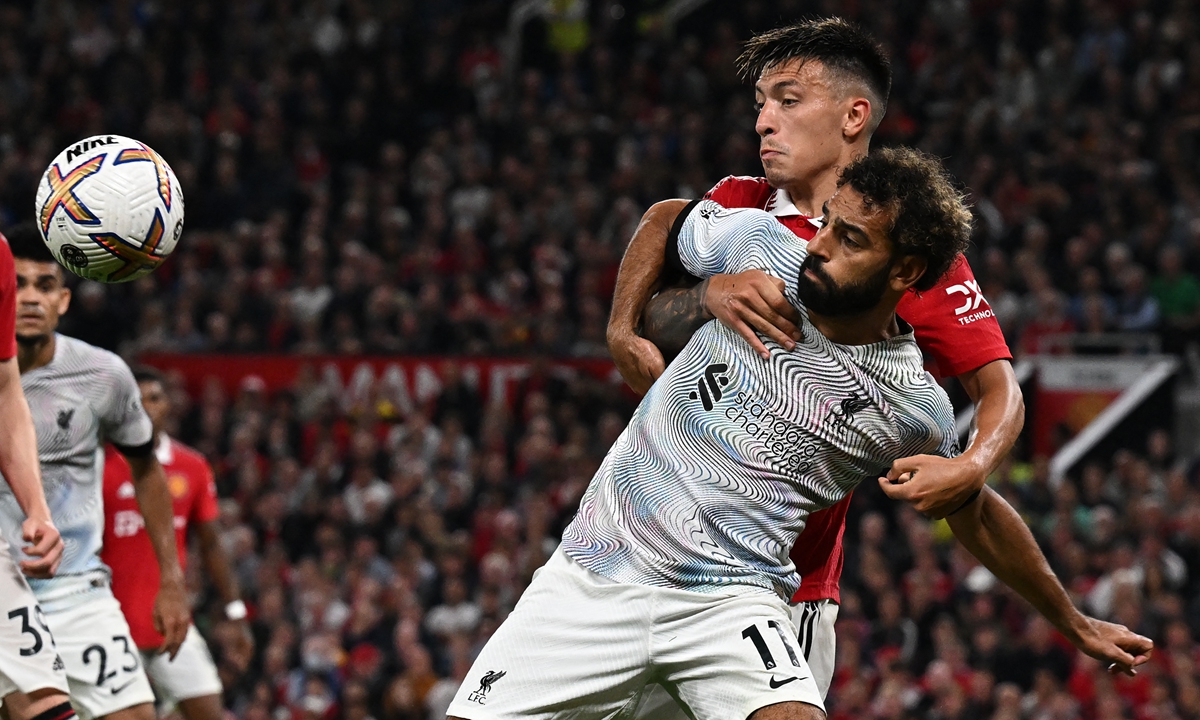 Liverpool's Mohamed Salah (back) vies with Manchester United's Lisandro Martinez during the English Premier League soccer match at Old Trafford in Manchester, England on August 22, 2022. Photo: AFP