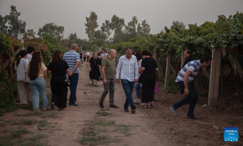 People visit a vineyard during a festival for grapes and agricultural products in Erbil, Iraq, on Aug. 23, 2022.(Photo: Xinhua)