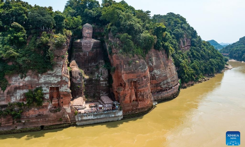 Aerial photo taken on Aug. 23, 2022 shows the Leshan Giant Buddha in southwest China's Sichuan Province. Facing the confluence of the Minjiang, Dadu and Qingyi rivers which saw the decrease of water level in recent days due to continuous high temperature, the base of the Leshan Giant Buddha became exposed above the water.(Photo: Xinhua)