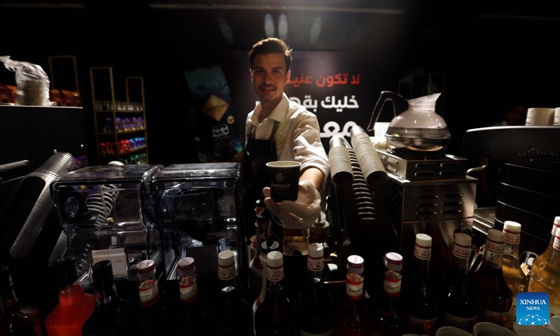 A barista poses with a cup of coffee during the 2022 Amman Coffee Festival in Amman, Jordan, on Aug. 25, 2022. The 2022 Amman Coffee Festival kicked off here on Thursday to promote the consumption of coffee products.(Photo: Xinhua)