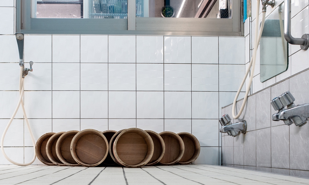 The exterior of the Inariyu, a sento or public bath, in the Takinogawa area of Tokyo, Japan Photos: AFP Buckets for visitors to use for washing themselves before entering the bath in the Inariyu