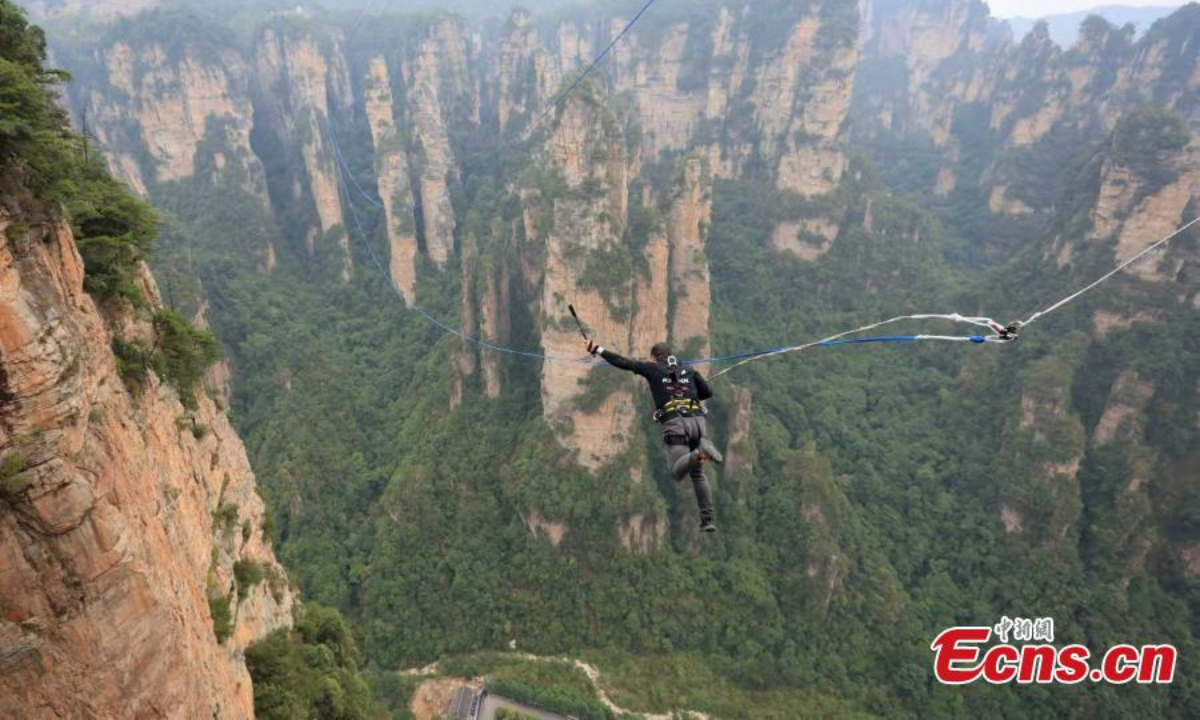 A participant jumps during the first rope swing challenge carnival held at Wulingyuan scenic spot in Zhangjiajie, central China's Hunan Province, Sep 15, 20. Photo: China News Service