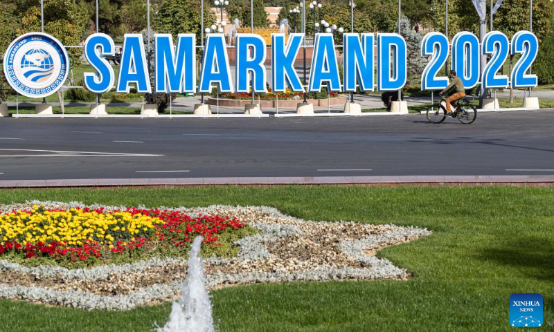 A man rides past a logo of the 22nd meeting of the Council of Heads of State of the Shanghai Cooperation Organization (SCO) in Samarkand, Uzbekistan on September 12, 2022. Photo: Xinhua