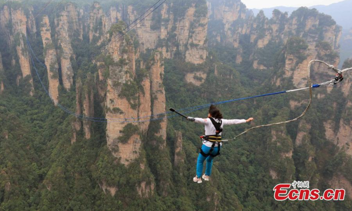 A participant jumps during the first rope swing challenge carnival held at Wulingyuan scenic spot in Zhangjiajie, central China's Hunan Province, Sep 15, 20. Photo: China News Service