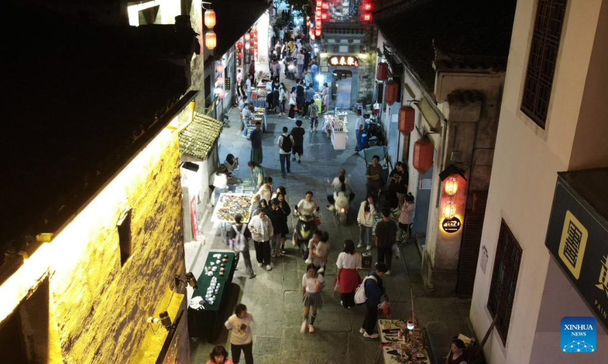 Aerial photo taken on Aug. 31, 2022 shows tourists visiting Hongcun Village in Yixian County, east China's Anhui Province. Hongcun Village deeply integrates night economy with tourism industry to promote rural development. Photo:Xinhua