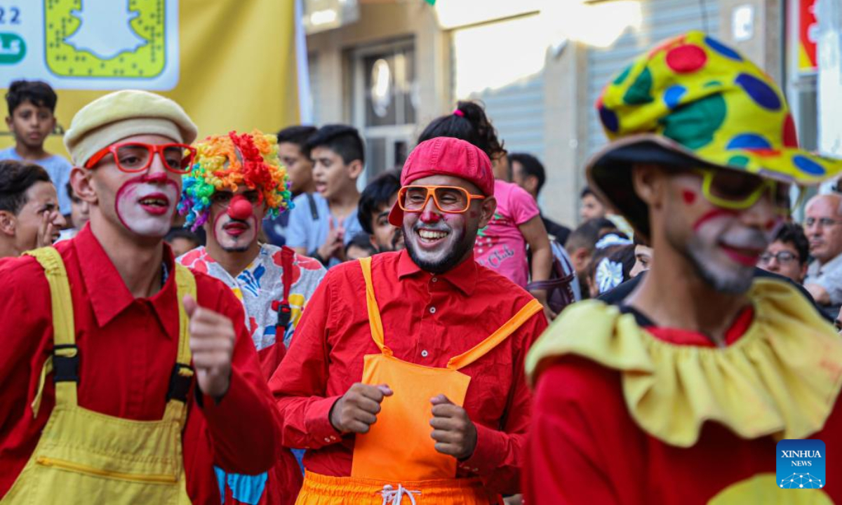 Palestinian young men dressed as clowns perform during an event to entertain children at Jabalia refugee camp in northern Gaza Strip, on Sep 8, 2022. Photo:Xinhua