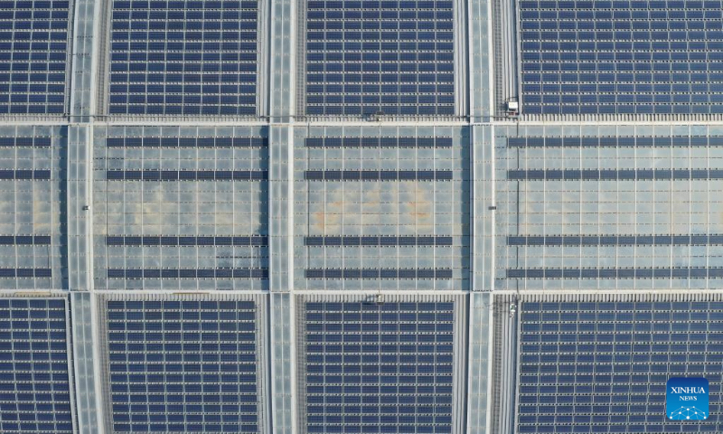 Aerial photo taken on Sept. 9, 2022 shows a distributed photovoltaic (PV) power station on the rooftop of the Xiong'an Railway Station in Xiong'an New Area, north China's Hebei Province. (Xinhua/Zhu Xudong)