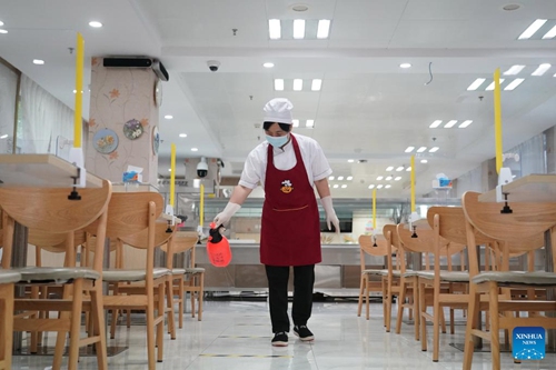 A staff member disinfects a canteen in Zhongguancun No.1 Primary School in Haidian District of Beijing, capital of China, Aug. 29, 2022. Schools in Zhongguancun area of Haidian District have organized staff members to make full preparation for the upcoming new semester. (Xinhua/Ren Chao)



