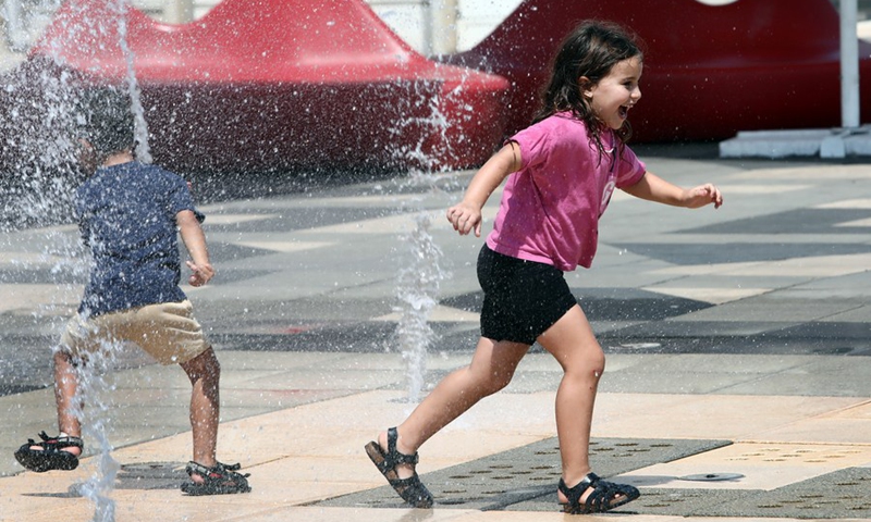 Children play in water fountains amid a heatwave in the central city of Tel Aviv, Israel on Aug. 29, 2022.(Photo: Xinhua)