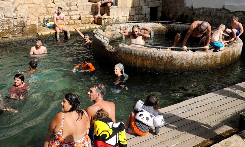 People spend time in spring water during a heatwave near Jerusalem on Aug. 29, 2022.(Photo: Xinhua)