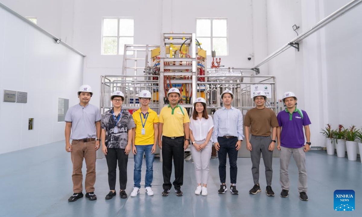 Scientists and engineers from Thailand pose for a photo in front of the Thailand Tokamak 1 (TT-1) machine in Hefei, east China's Anhui Province, Aug. 24, 2022. A group of scientists and engineers from Thailand are currently conducting research and experiments related to fusion energy with their Chinese colleagues in Hefei. (Xinhua/Zhao Jinzheng)

