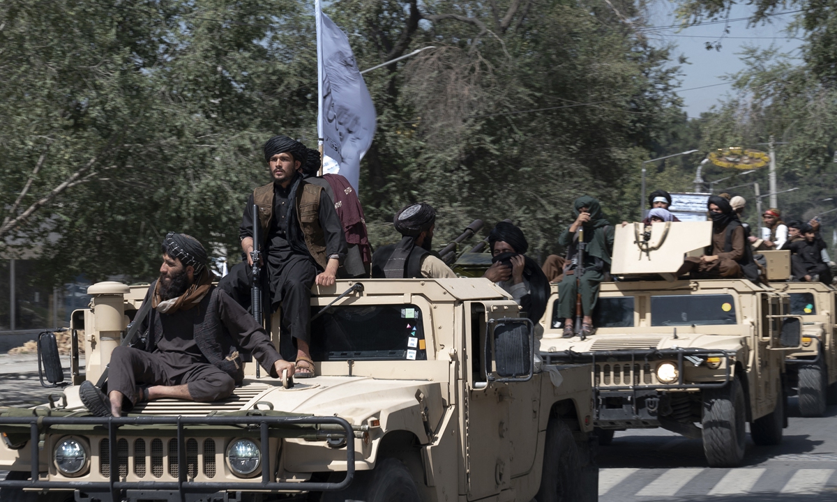 Armed Taliban fighters parade atop humvee vehicles as they celebrate the first anniversary of the withdrawal of US-led troops from Afghanistan, near the former US embassy in Kabul on August 31, 2022. Photo: AFP