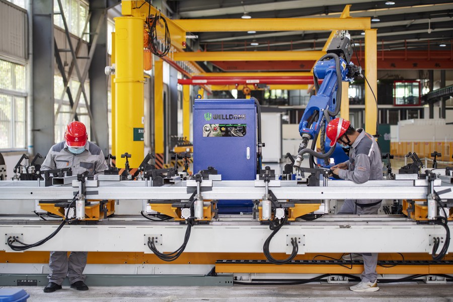 Staff members work at the workshop of the Anhui Electric Power Transmission & Transformation Co., Ltd. in Hefei, east China's Anhui Province, May 13, 2022.(Xinhua)



