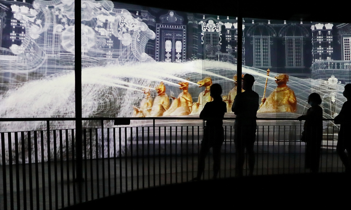 A bronze Chinese zodiac horse head, which was looted from the Old Summer Palace in Beijing in 1860, returned in 2020. Photo: VCG People look at a digital recreation of an Old Summer Palace fountain featuring 12 bronze Chinese zodiac statues at an exhibition held in Beijing in July 2020. Photo: VCG