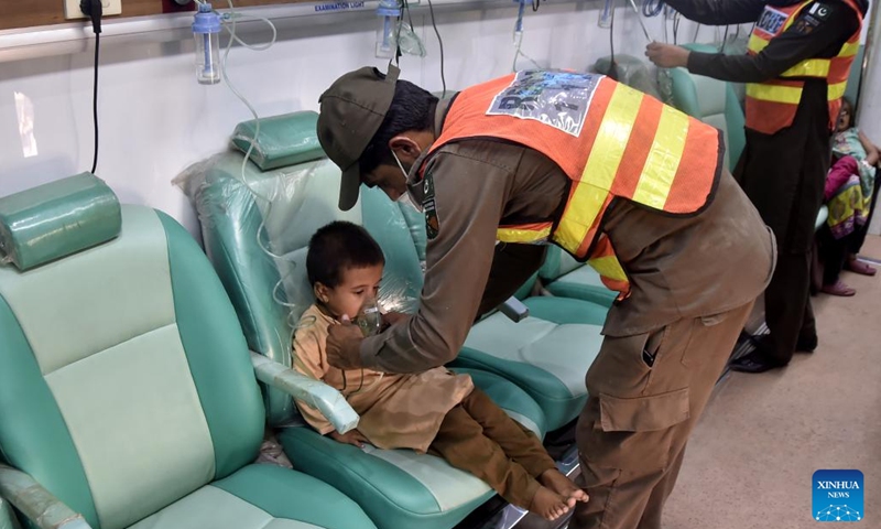 A rescuer gives medical treatment to a flood-affected child at a makeshift hospital in northwest Pakistan's Charsadda on Aug. 31, 2022. The total death toll in Pakistan from this season's monsoon rains since mid-June has risen to at least 1,162, along with 3,554 others injured, the National Disaster Management Authority (NDMA) said.(Photo: Xinhua)