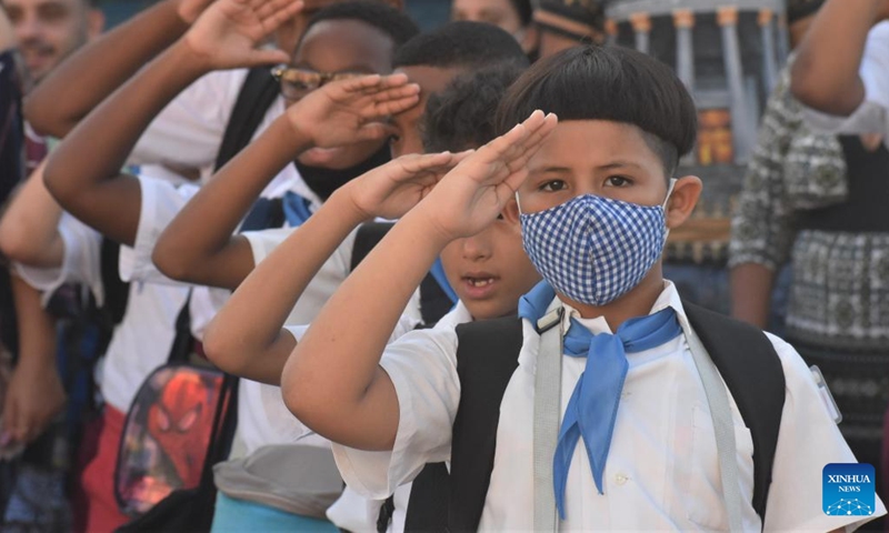Students salute at the opening ceremony of a new semester in Havana, Cuba, Sept. 5, 2022. (Xinhua/Zhu Wanjun)