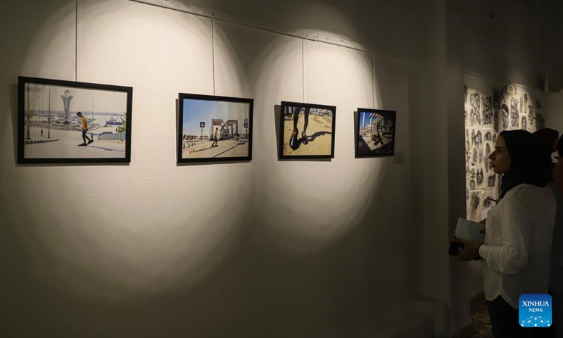 A Palestinian woman views artworks during an exhibition called No One Yearns for Pain at Shababek for Contemporary Art in Gaza City, on Aug. 31, 2022.(Photo: Xinhua)