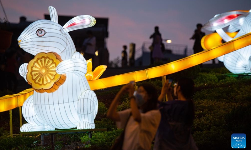 People take photo of illumination installations in front of the Ruins of the St. Paul's in Macao, south China, Sept. 3, 2022.Photo:Xinhua