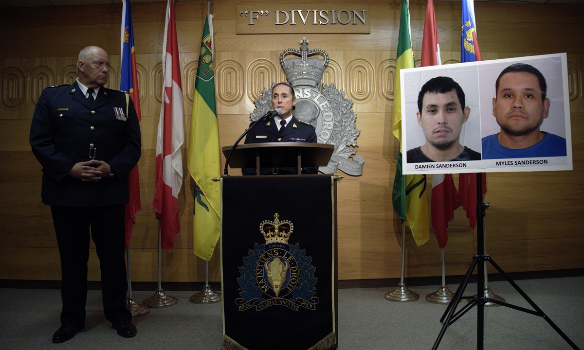 Assistant Commissioner Rhonda Blackmore (right) speaks while Regina Police Chief Evan Bray looks on during a press conference at RCMP 
